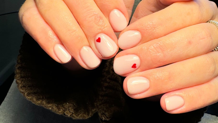 Elegant nail art with red hearts at Katies Beauty Room, Weston-super-mare, England, GB.