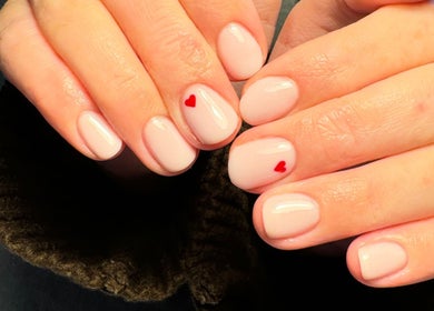 Elegant nail art with red hearts at Katies Beauty Room, Weston-super-mare, England, GB.