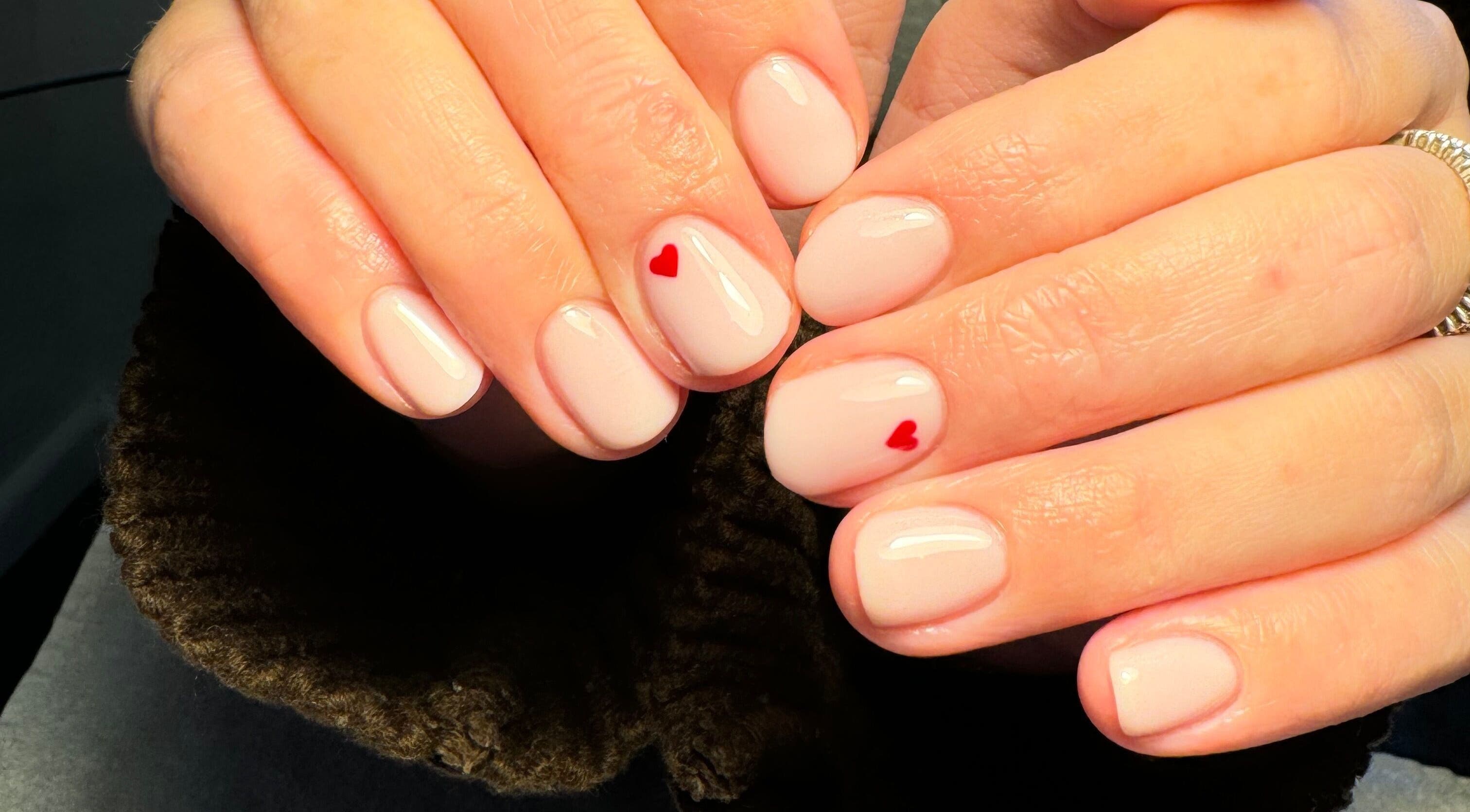 Elegant nail art with red hearts at Katies Beauty Room, Weston-super-mare, England, GB.
