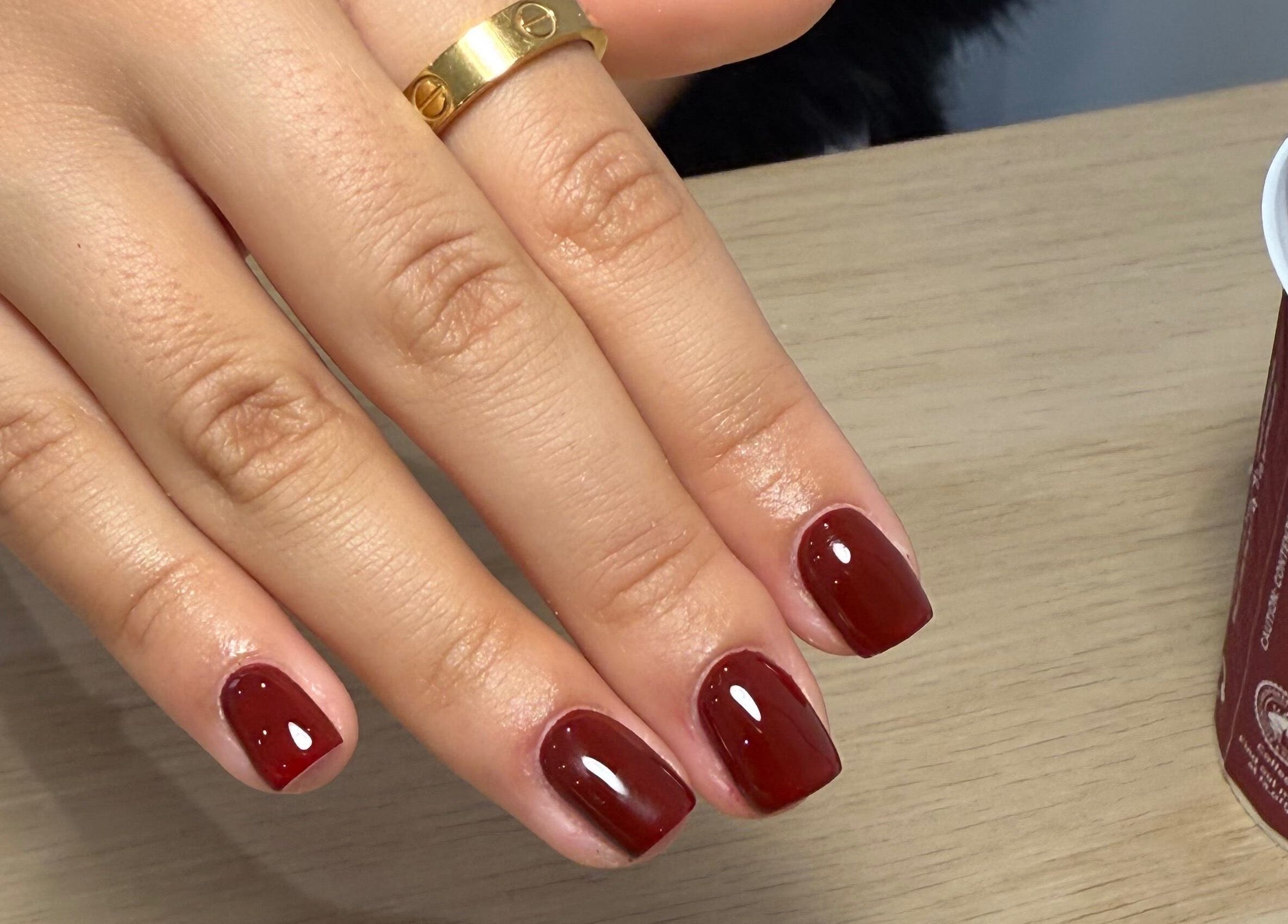 Elegant red nails with glossy finish at Maybe Beauty Studio, Tadcaster, England, GB.
