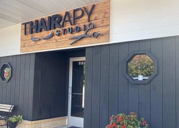 T'Hairapy Studio's stylish entrance in Kenosha, Wisconsin, US with modern signage and decor.
