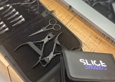 Professional hair tools at T'Hairapy Studio, Kenosha, Wisconsin, US, showcasing scissors and clips.