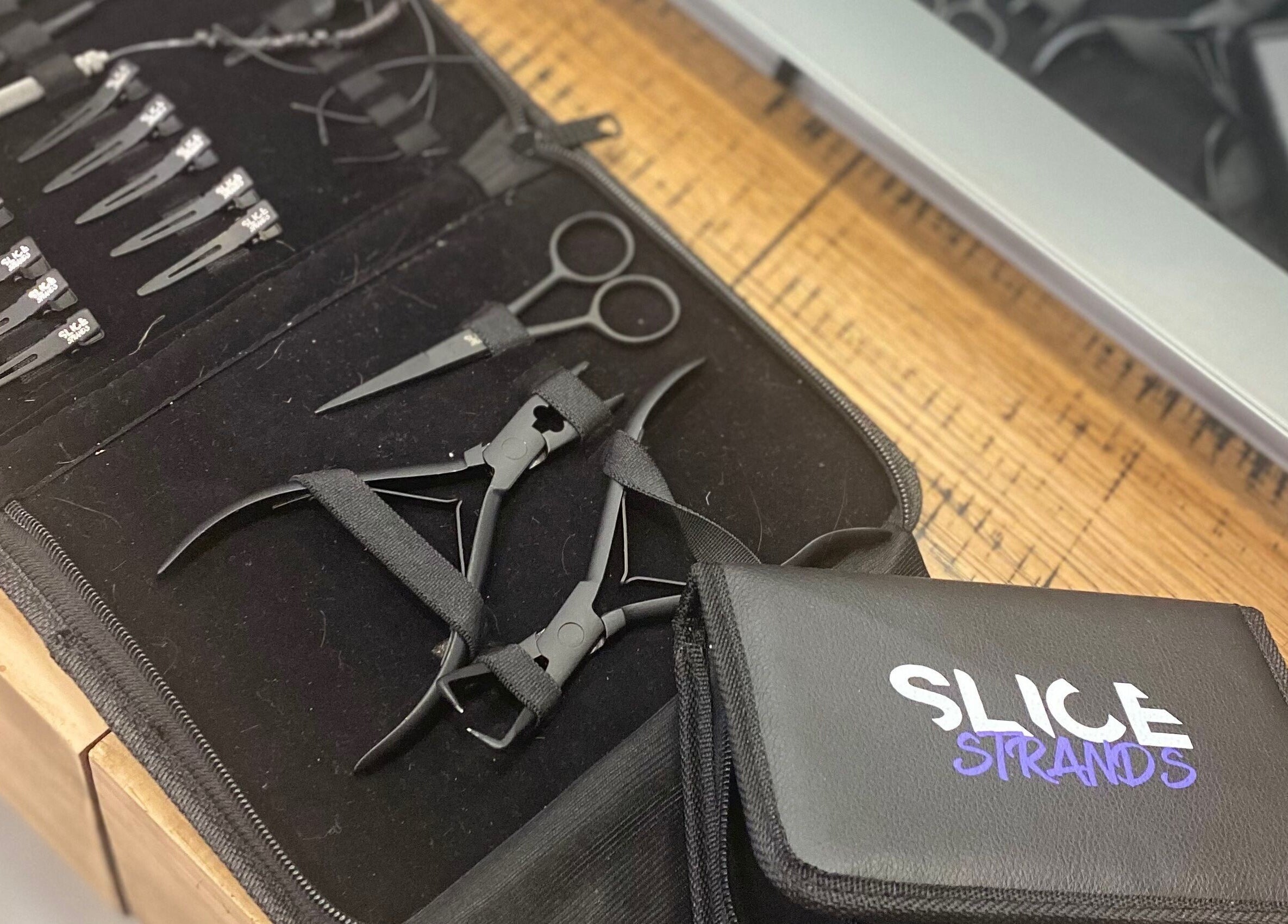 Professional hair tools at T'Hairapy Studio, Kenosha, Wisconsin, US, showcasing scissors and clips.