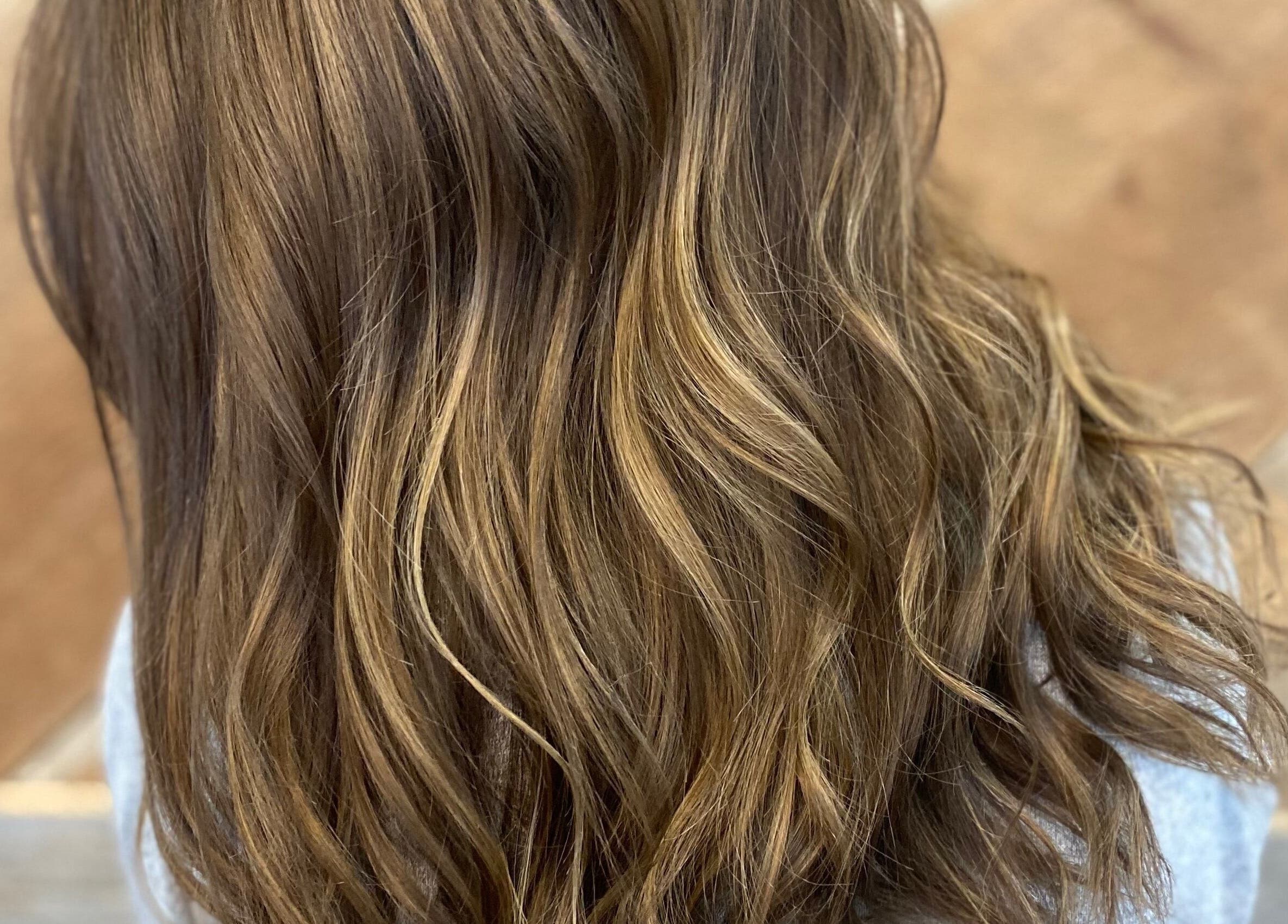 Flowing wavy hair with highlights at T'Hairapy Studio, Kenosha, Wisconsin, US.