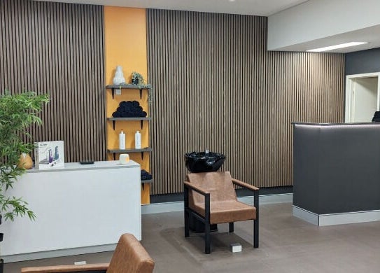 Chic interior of Cuts By Carella in Cairns City, Queensland, AU with modern decor and welcoming atmosphere.