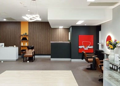Modern, chic salon interior at Cuts By Carella in Cairns City, Queensland, AU with stylish decor and seating.