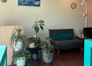 Inviting lounge area at Deep Tissue Therapies, Bondi, New South Wales, AU, featuring lush plants and cozy seating.