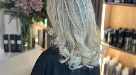 Styled blonde hair at Adele Branch Hair, Kirkintilloch, Scotland, GB showcasing soft curls and premium products.