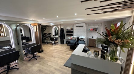 Modern interior of Adele Branch Hair, Kirkintilloch, Scotland, GB with stylish salon stations and florals.