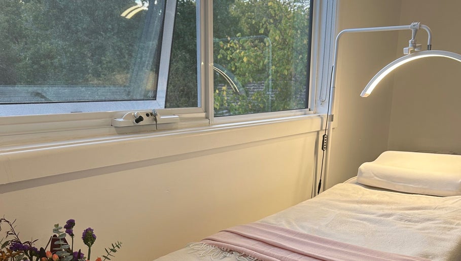 A tranquil spa bed at BBA - Beauty By Aileah, Melbourne, Victoria, AU, next to a sunlit window.