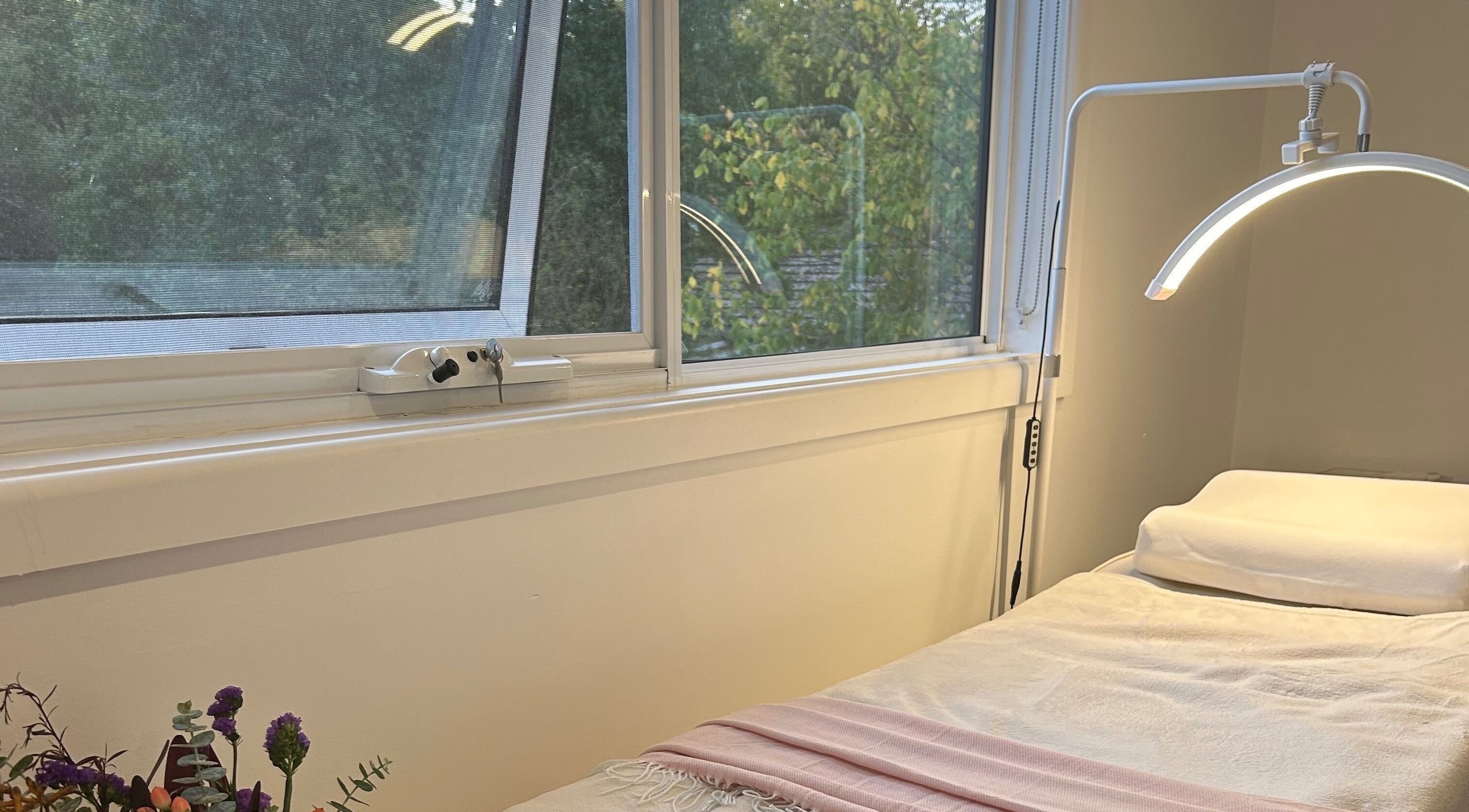 A tranquil spa bed at BBA - Beauty By Aileah, Melbourne, Victoria, AU, next to a sunlit window.