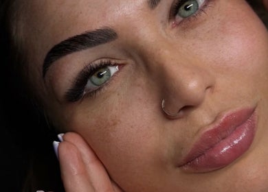 Close-up of a woman's face showcasing eyebrow and lip enhancement at Gyulya Yelaiah Beauty and Academy, Dublin, IE.