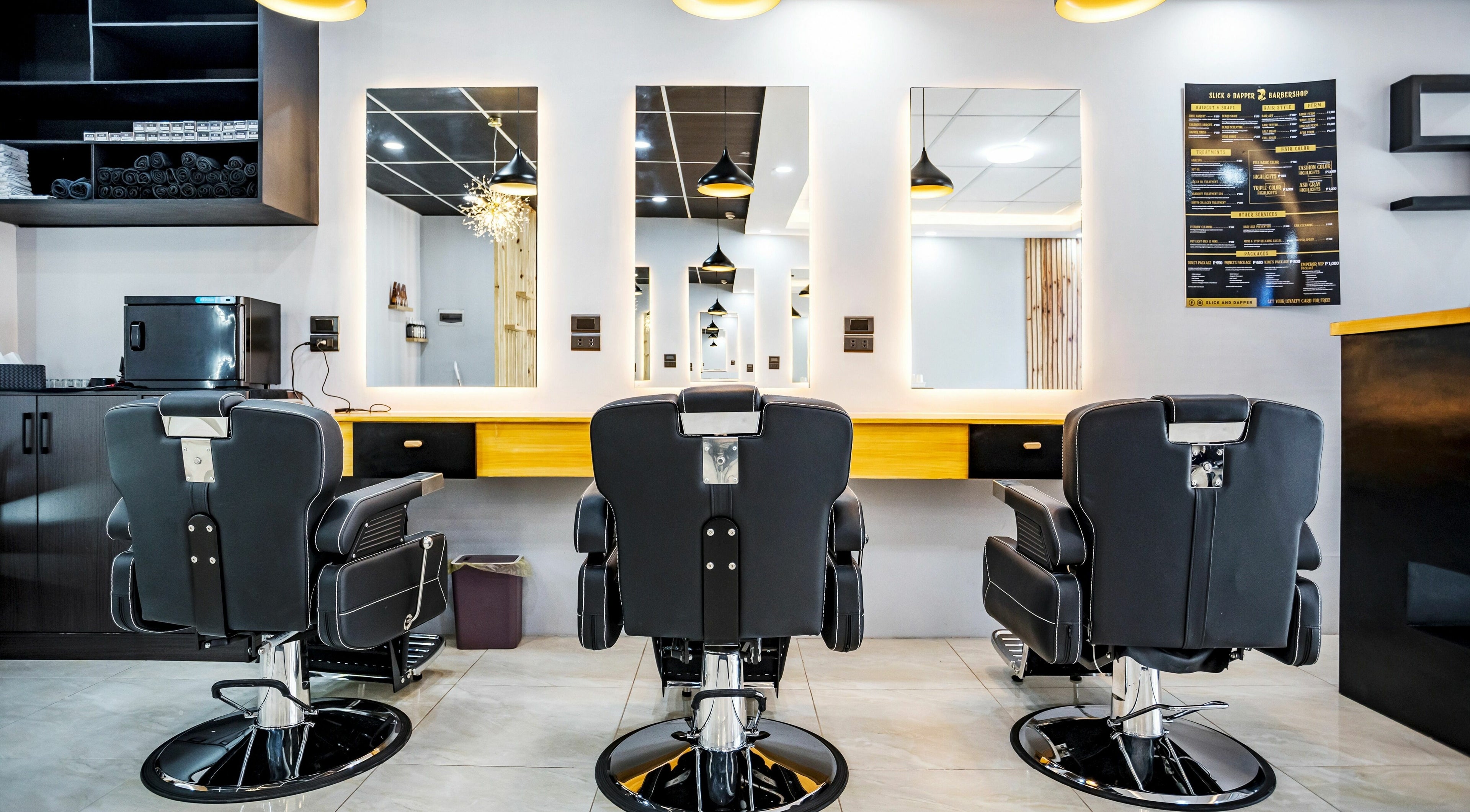 Modern barber chairs and mirrors at Slick and Dapper Barbershop and Salon Guadalupe in Cebu City, Central Visayas, PH.