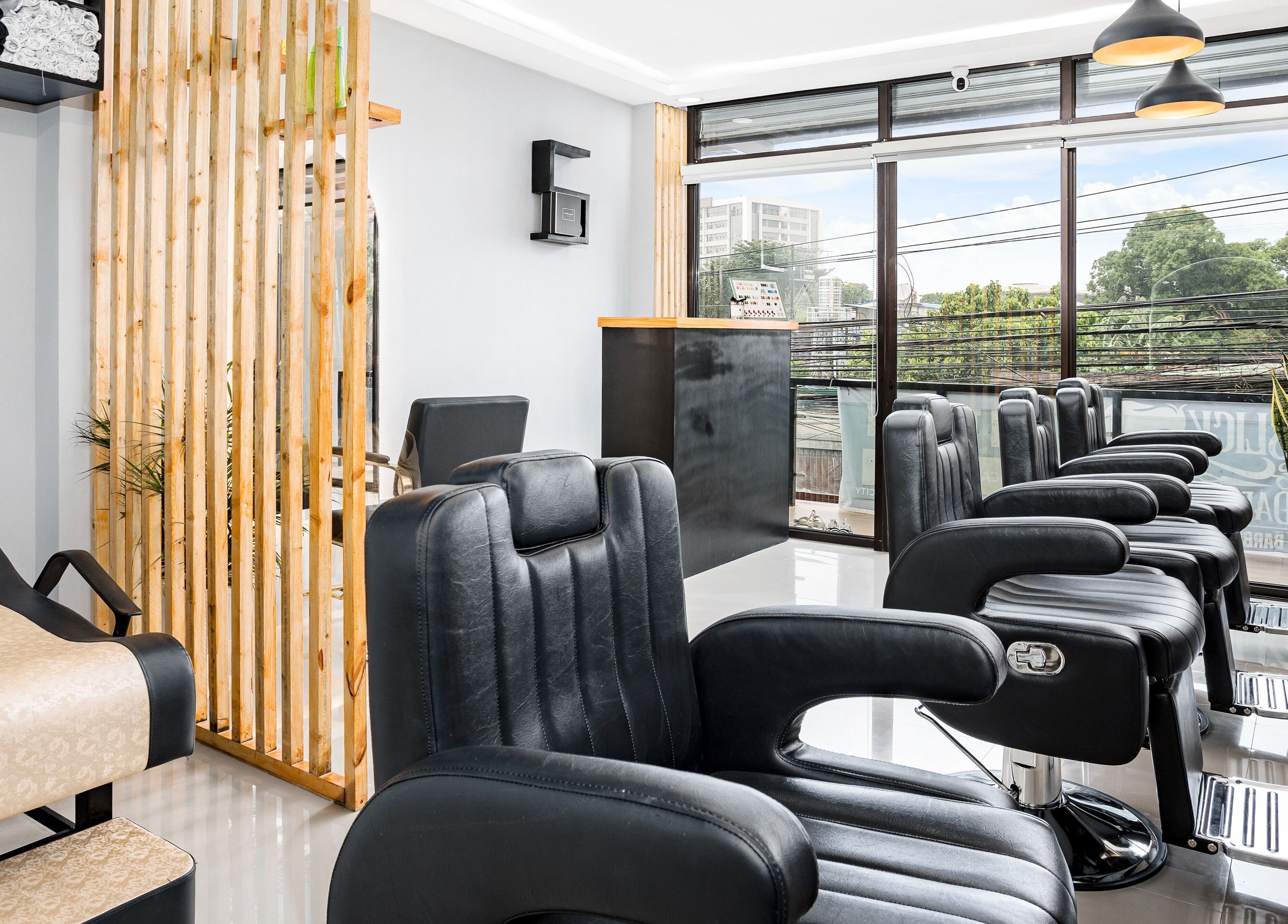 Modern interior of Slick and Dapper Barbershop and Salon Capitol, Cebu City, Central Visayas, PH, showcasing chic chairs.