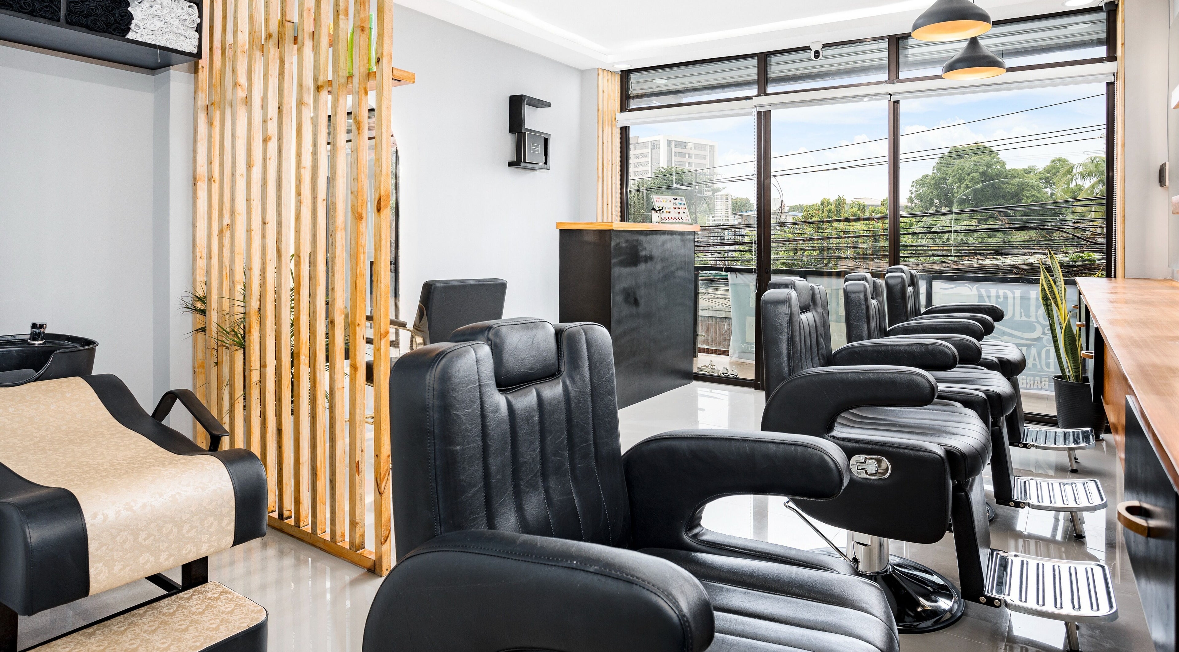 Modern interior of Slick and Dapper Barbershop and Salon Capitol, Cebu City, Central Visayas, PH, showcasing chic chairs.