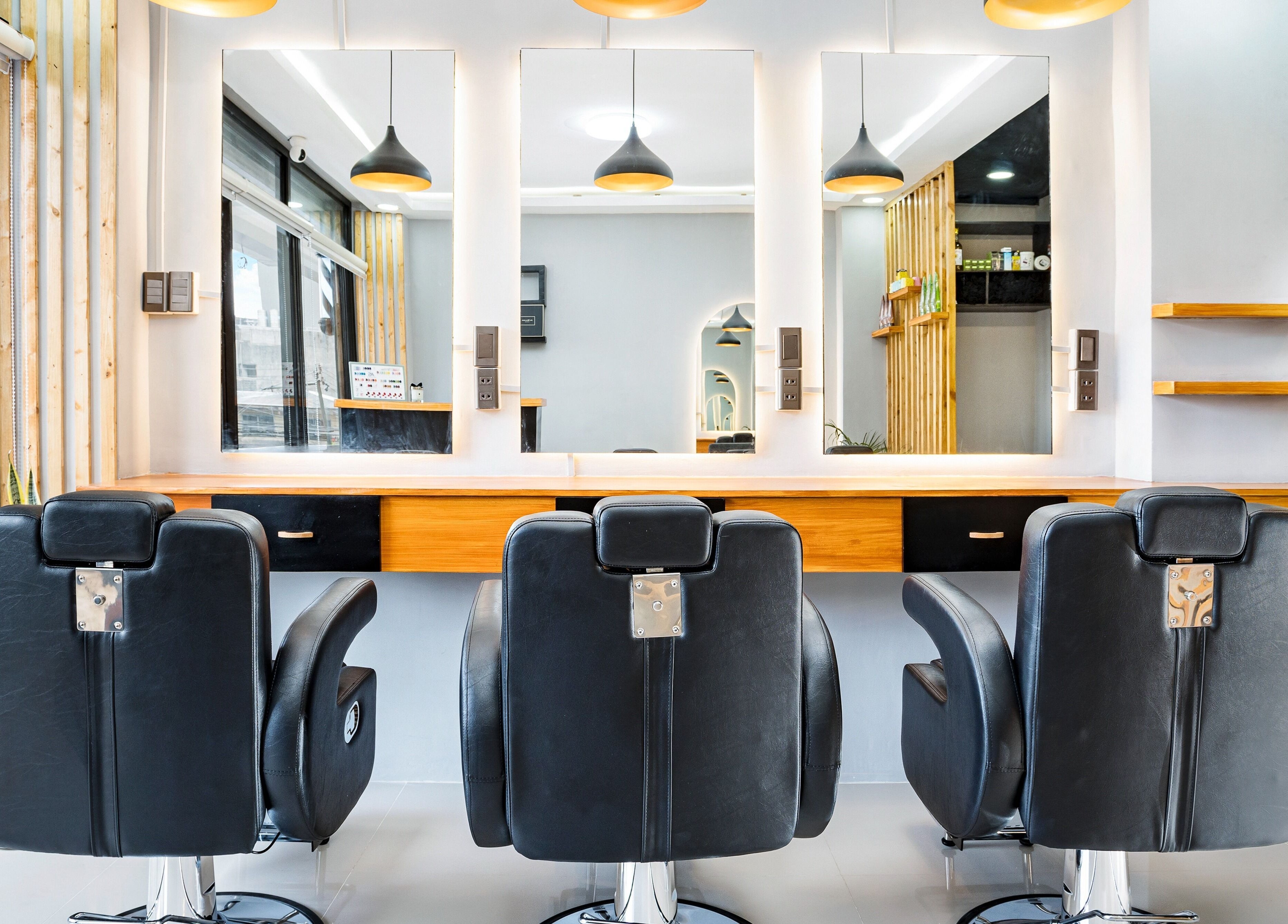 Modern chairs and mirrors at Slick and Dapper Barbershop and Salon Capitol, Cebu City, Central Visayas, PH.