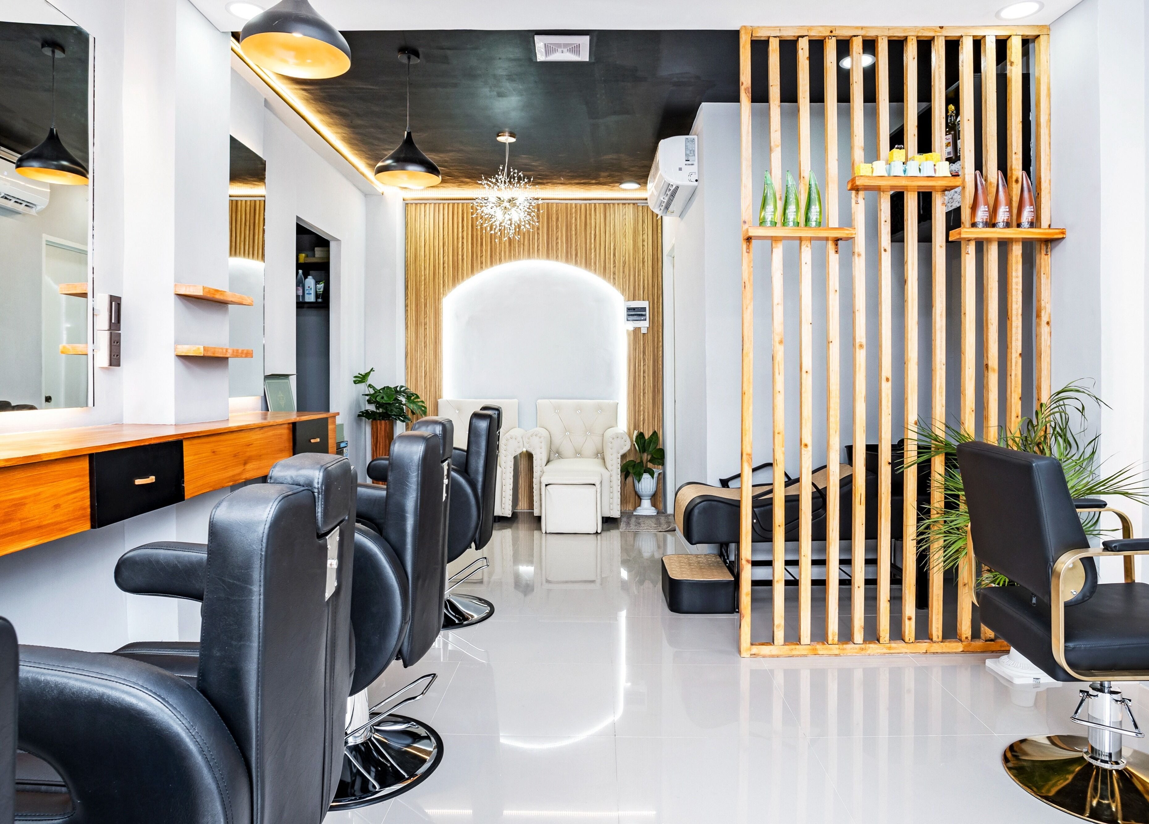 Modern interior of Slick and Dapper Barbershop and Salon Capitol in Cebu City, Central Visayas, PH with stylish chairs.