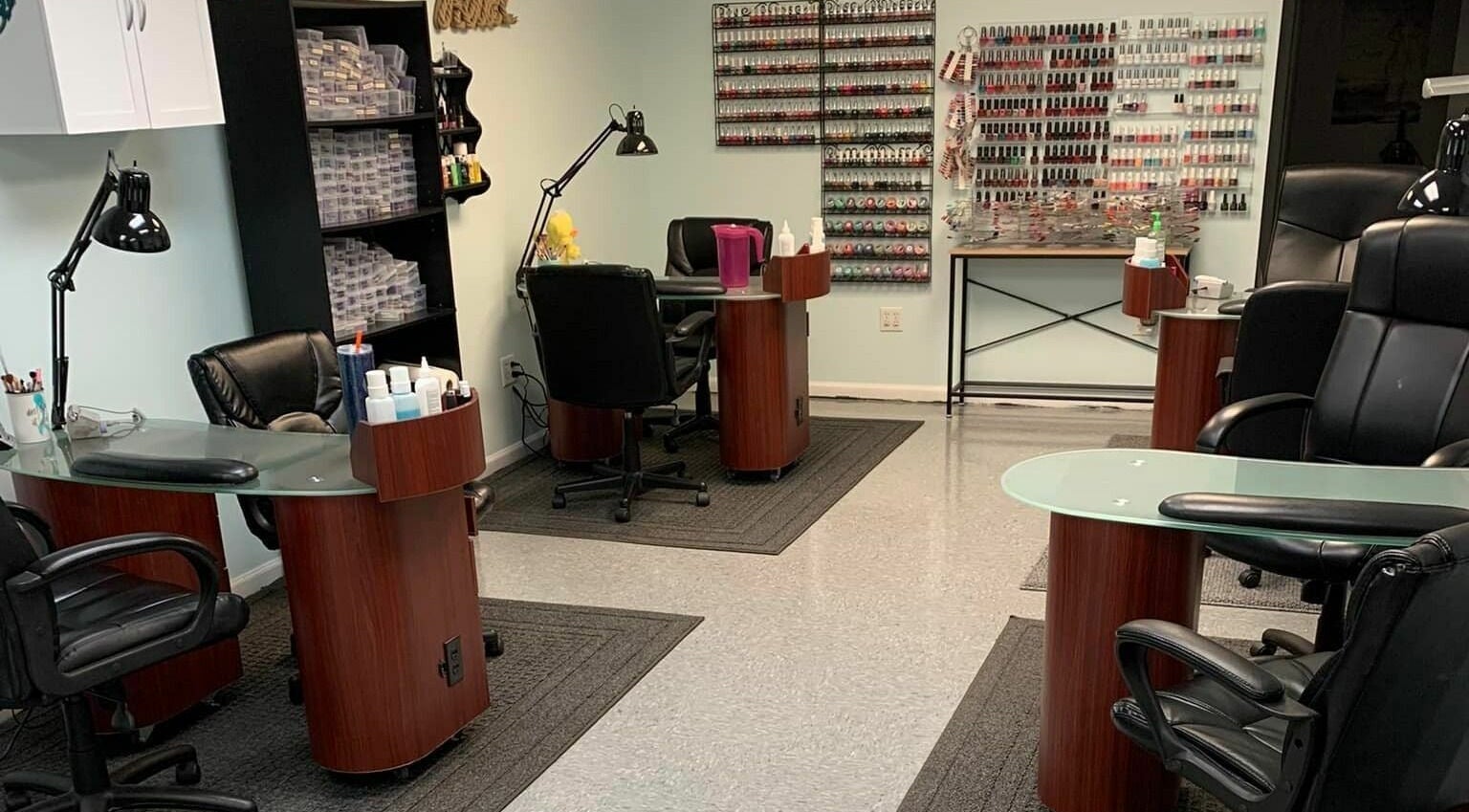 Modern nail station at Hair'N Dip-ity, Littlestown, Pennsylvania, US, featuring sleek chairs and polished desks.