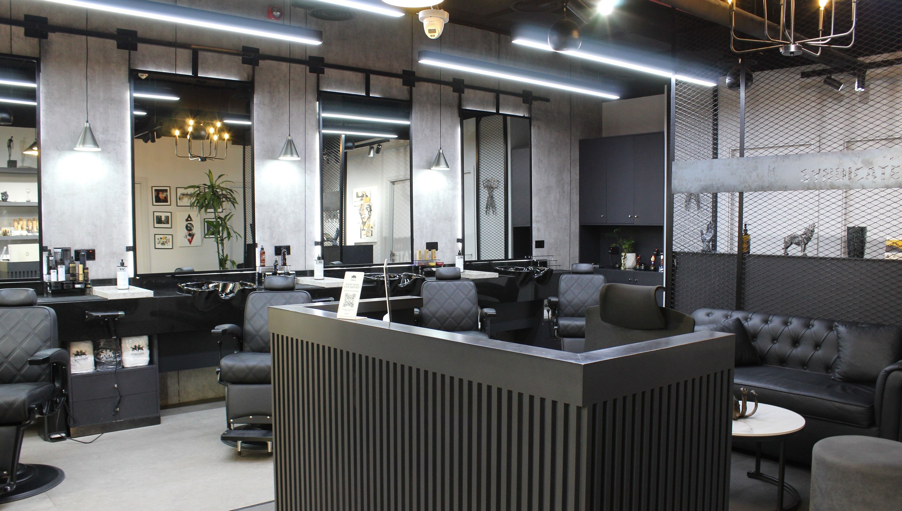 Stylish interior of The Syndicate Gents Salon in Dubai, AE, featuring modern barber chairs and sleek decor.