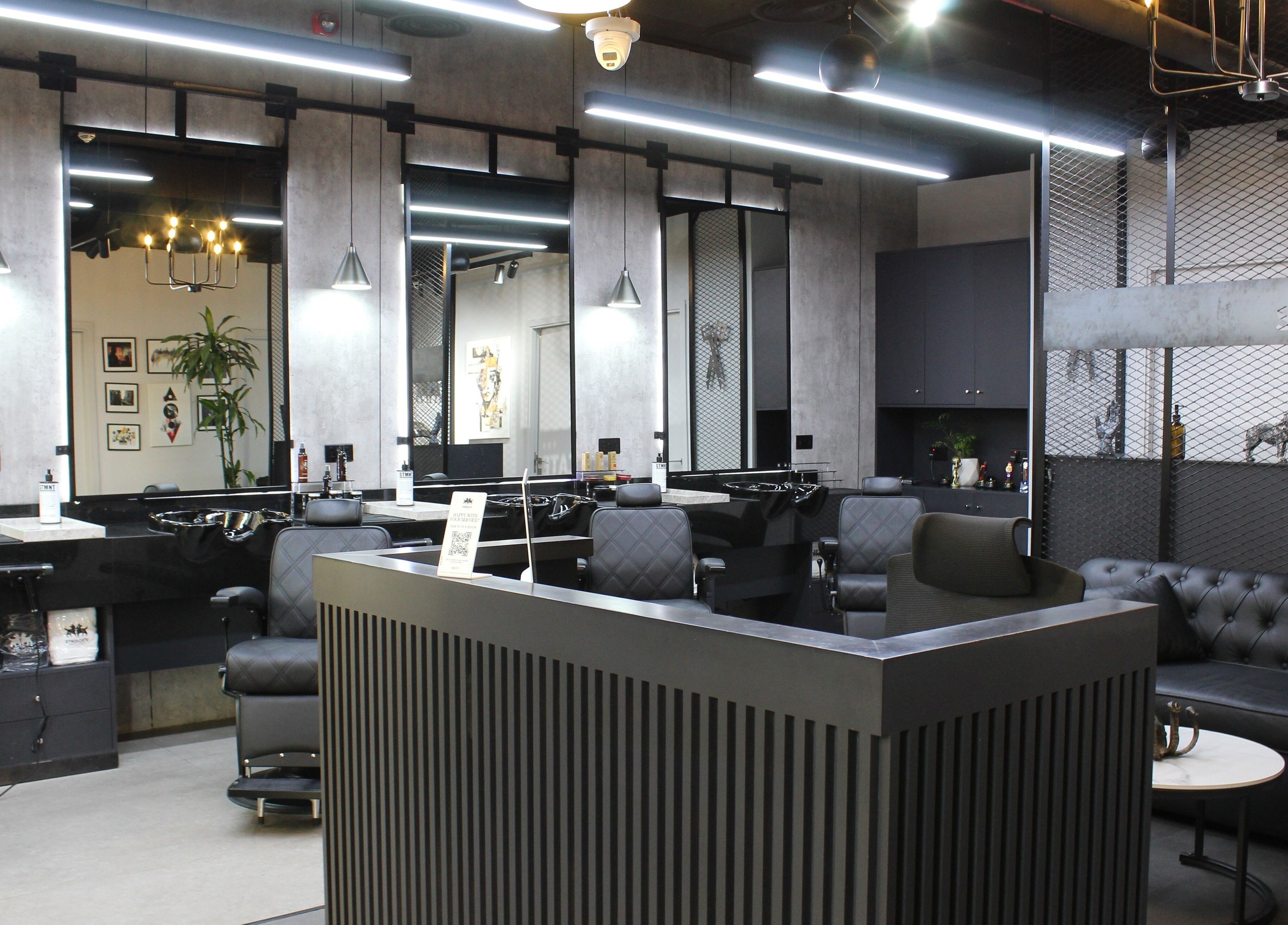 Stylish interior of The Syndicate Gents Salon in Dubai, AE, featuring modern barber chairs and sleek decor.