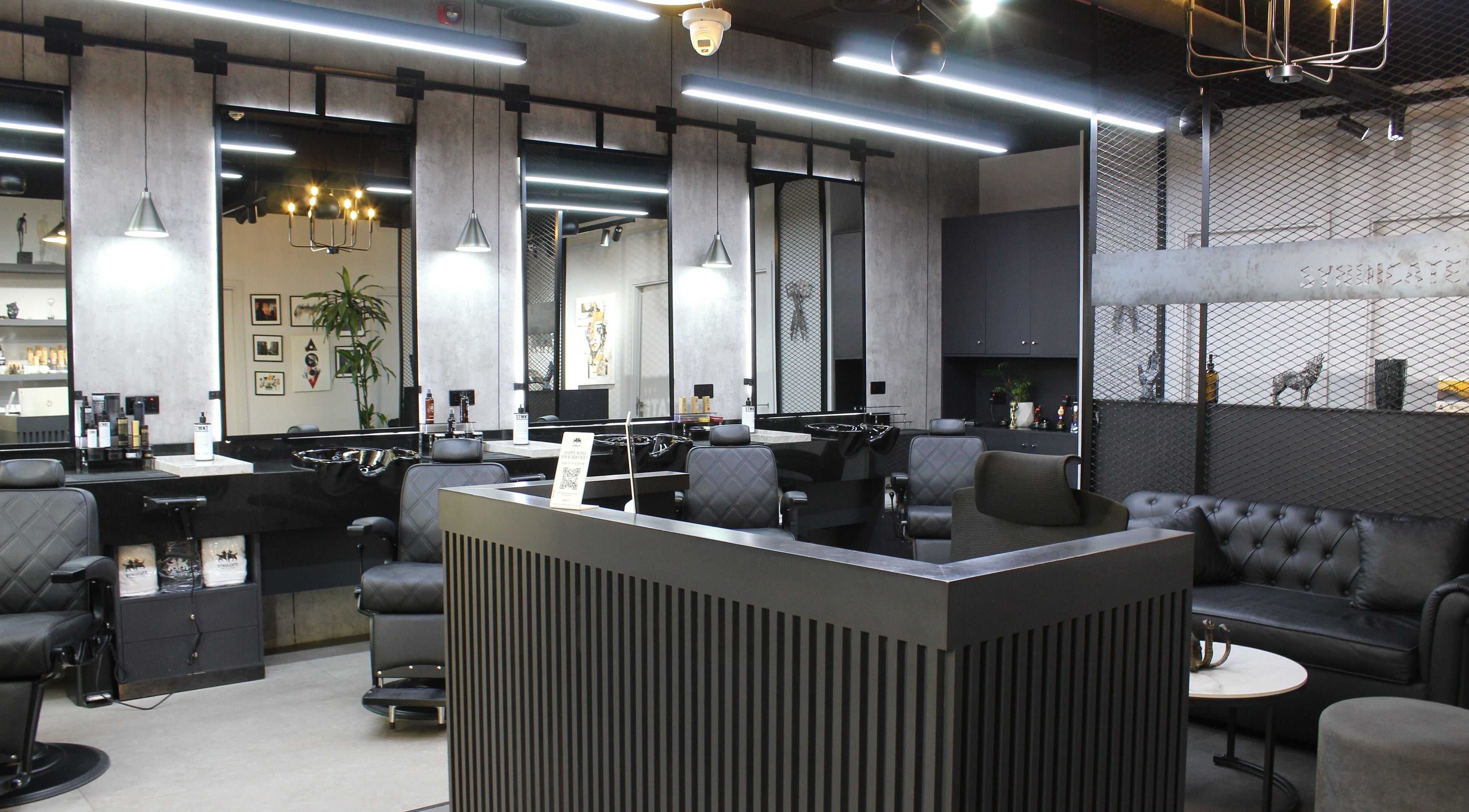 Stylish interior of The Syndicate Gents Salon in Dubai, AE, featuring modern barber chairs and sleek decor.