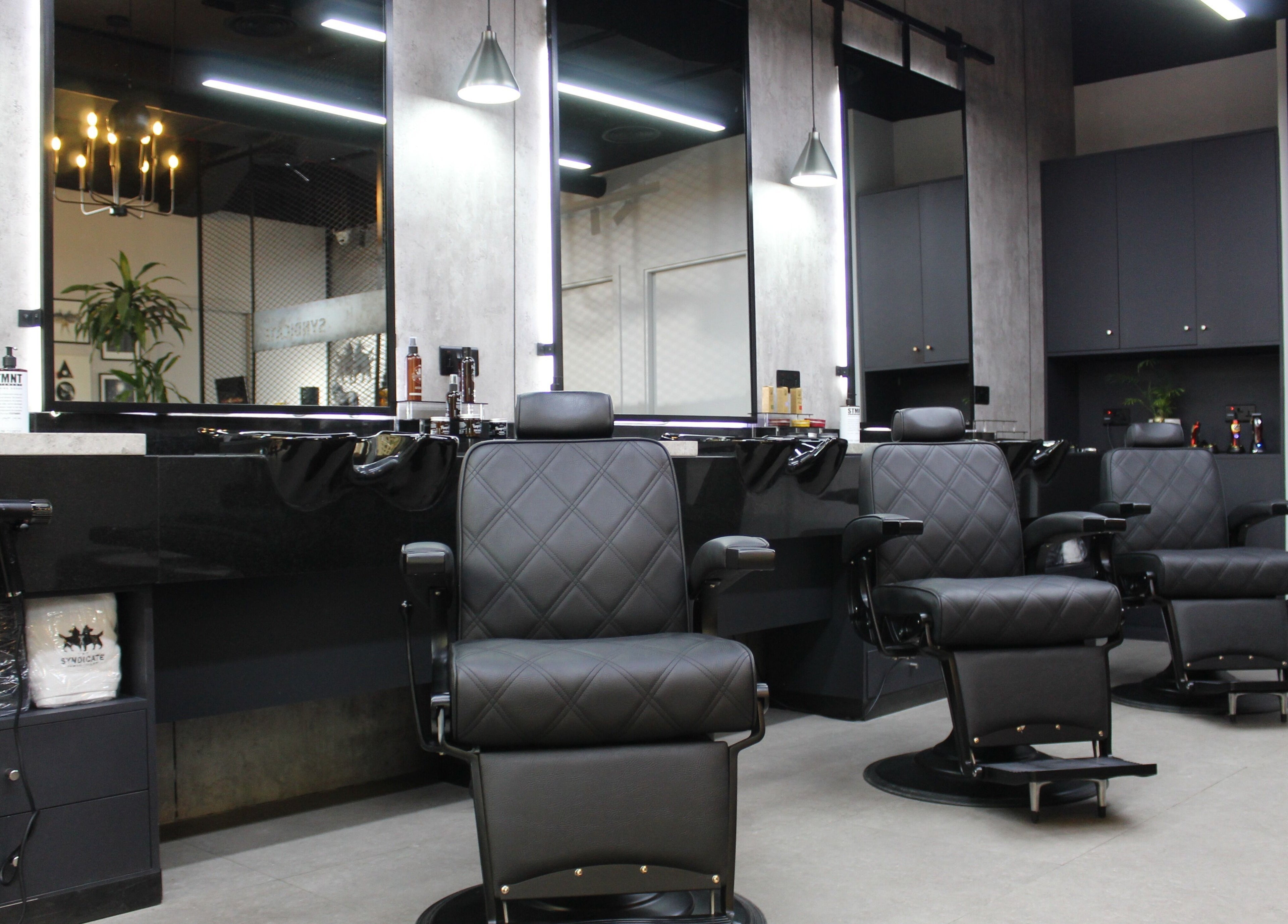 Luxurious styling chairs in The Syndicate Gents Salon, Dubai, AE, offering premium grooming services.