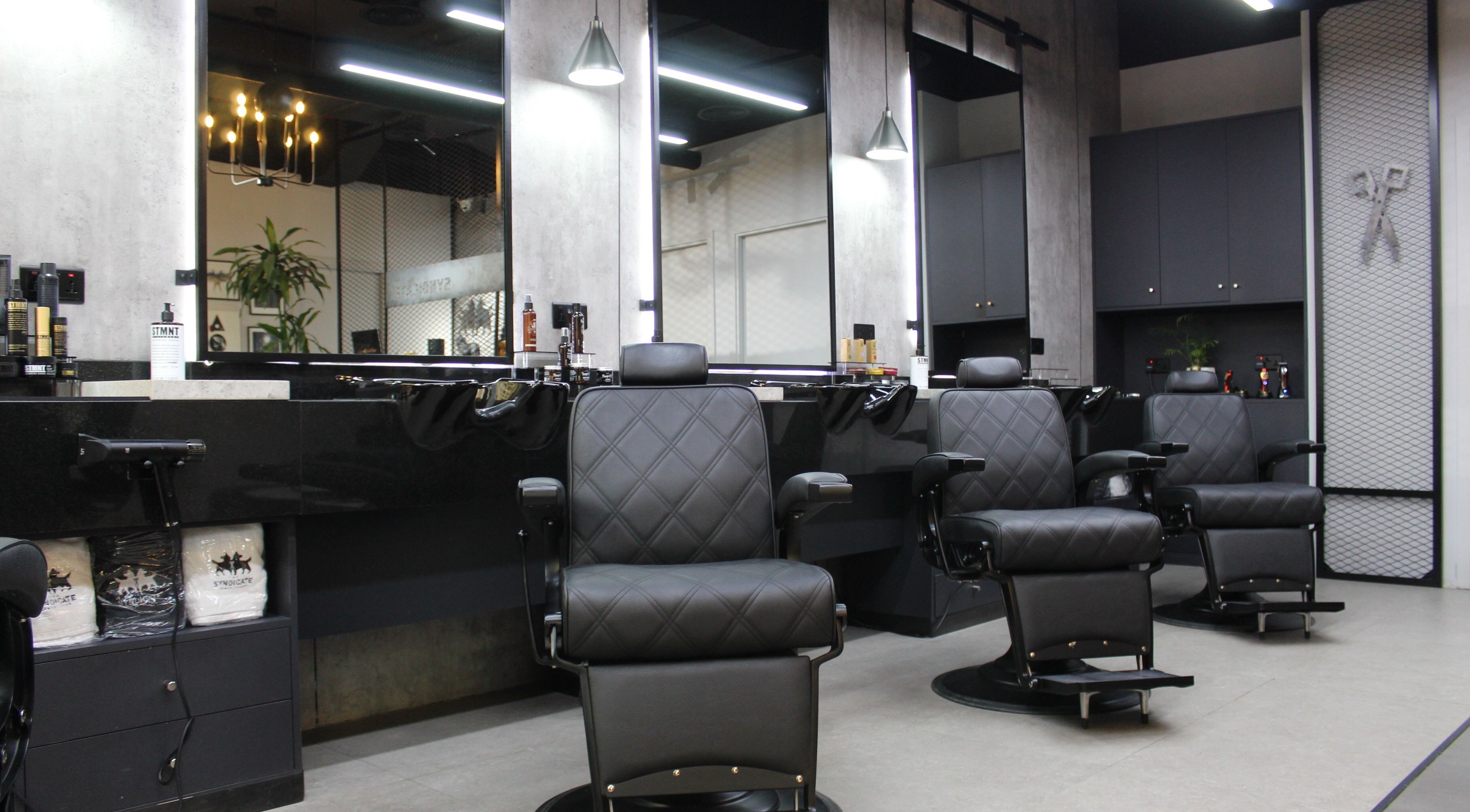 Luxurious styling chairs in The Syndicate Gents Salon, Dubai, AE, offering premium grooming services.