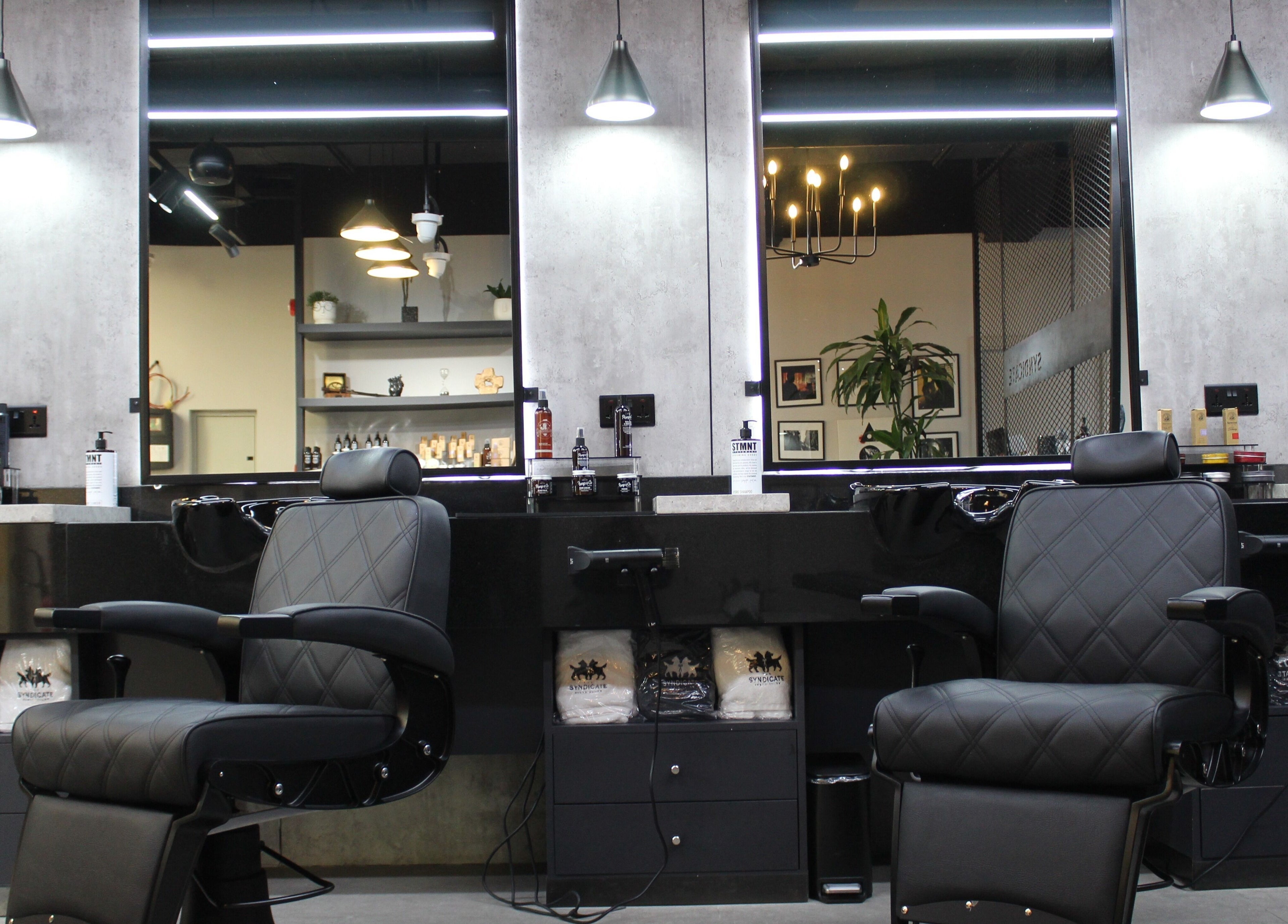 Elegant barber chairs at The Syndicate Gents Salon, Dubai, AE, offering a premium grooming experience.