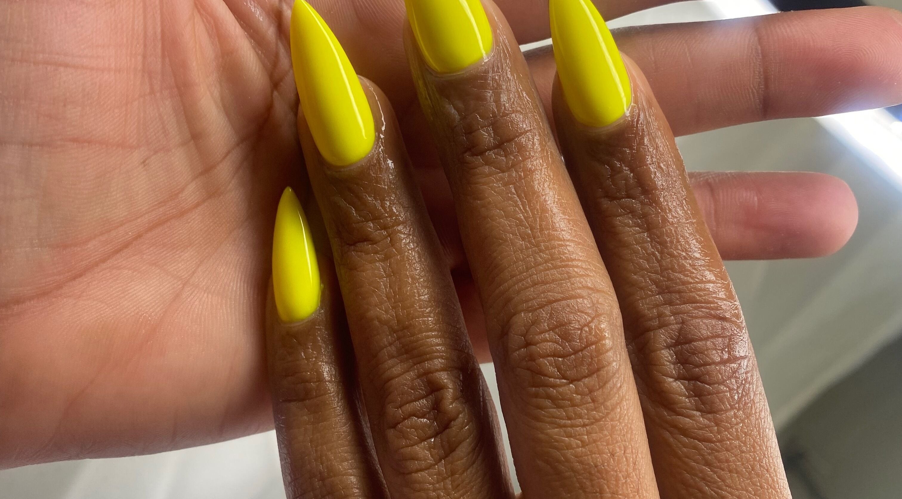 Bright yellow nails styled at Rasheedas Tips And Toes, Montego Bay, St. James, JM.
