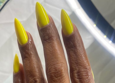 Bright neon yellow nails at Rasheedas Tips And Toes, Montego Bay, St. James, JM, showcasing expert nail artistry.