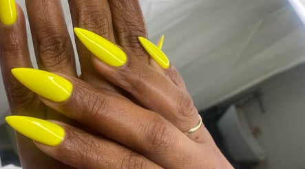 Bright yellow stiletto nails at Rasheedas Tips And Toes, Montego Bay, St. James, JM.