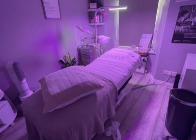 Relaxing treatment room at The Renewed Lab in Harrold, England, GB with purple ambiance and clean aesthetic.