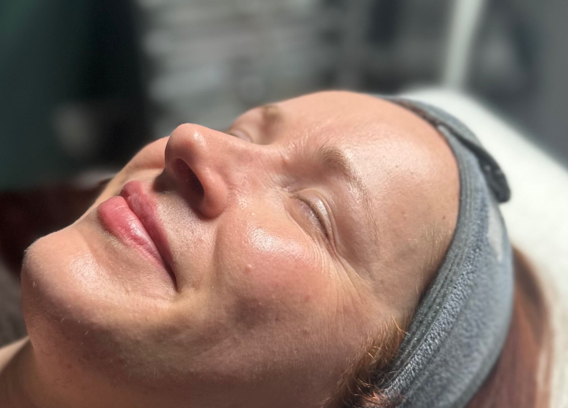 Woman enjoying a facial treatment at The Renewed Lab, Harrold, England, GB.