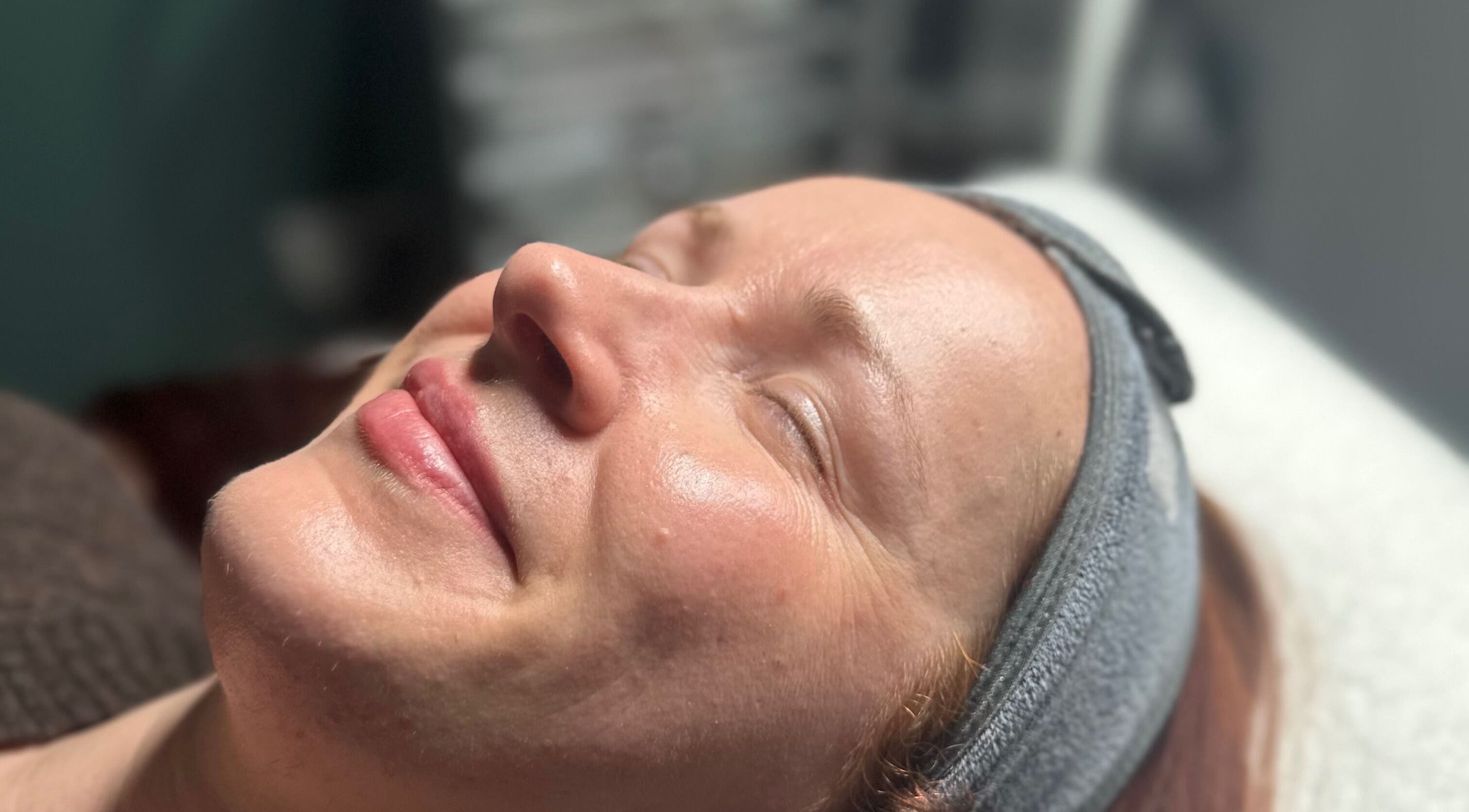 Woman enjoying a facial treatment at The Renewed Lab, Harrold, England, GB.