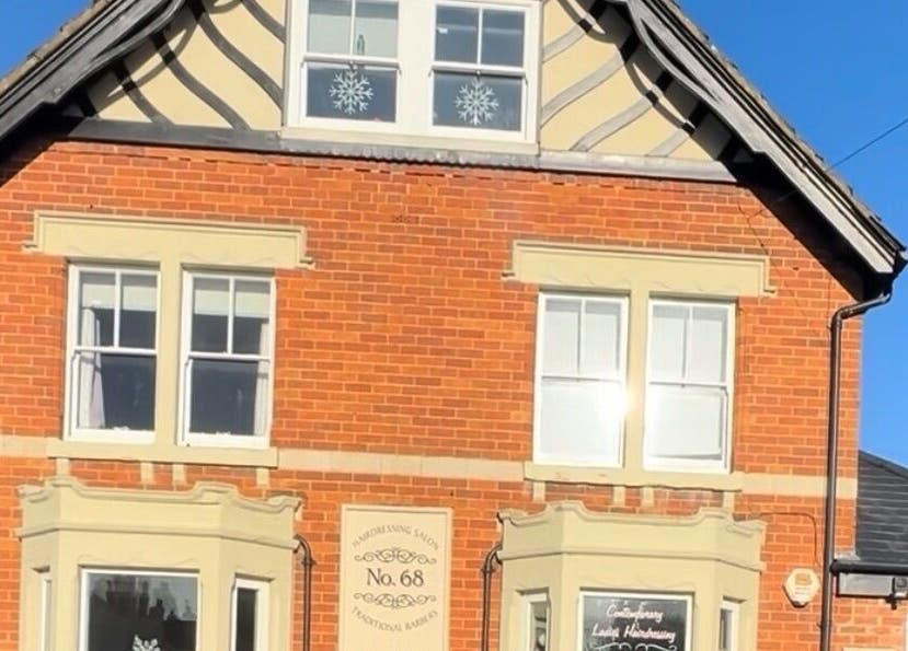 The Renewed Lab venue, a cozy red-brick building in Harrold, England, GB, under a clear blue sky.