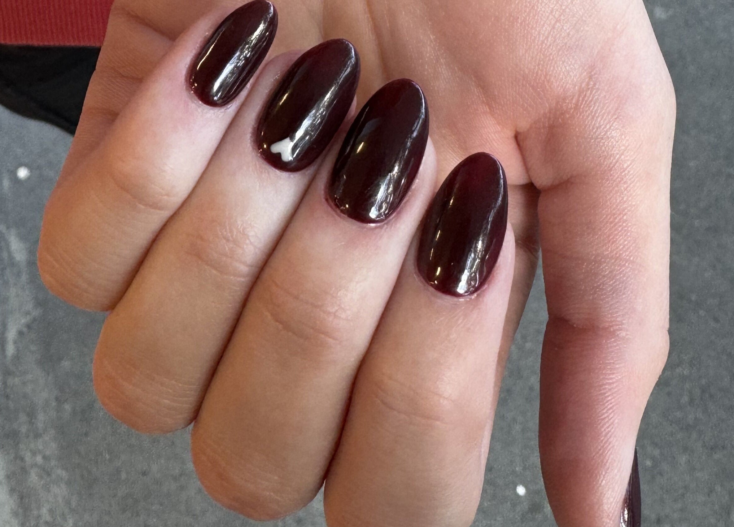 Dark burgundy nails with a glossy finish at Painted, Darlinghurst, New South Wales, AU.