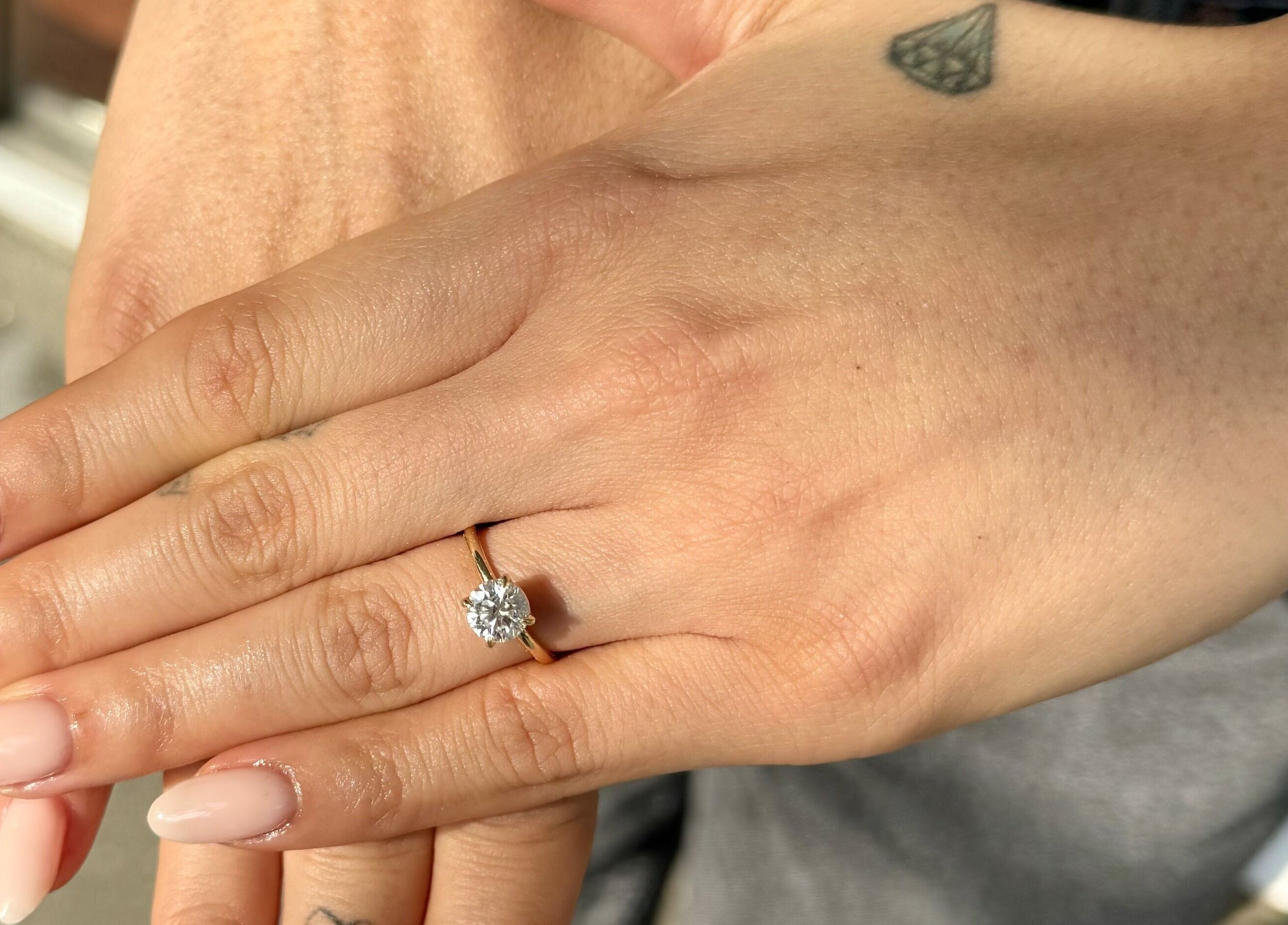 Manicured hands with elegant ring in sunlight at Painted, Darlinghurst, New South Wales, AU.