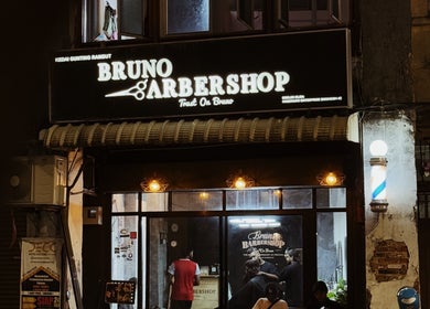 Bruno Barbershop (1st Outlet) in George Town, Pulau Pinang, MY, warmly lit exterior with classic barber pole.