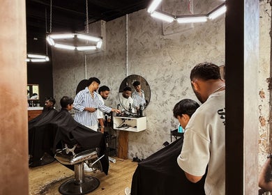 Barbers working at Bruno Barbershop (1st Outlet) in George Town, Pulau Pinang, MY, showcasing a trendy interior.