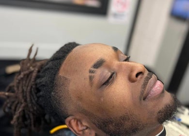 Relaxed client receiving a haircut at Columbia | Sacred Diamond Groom + Well, Columbia, Tennessee, US.