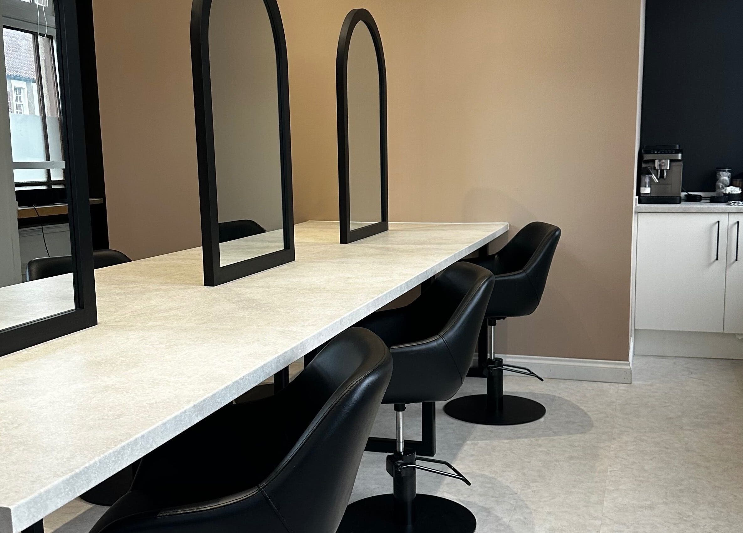 Modern seating area with sleek mirrors at Exhibit Studio, Uphall, Scotland, GB.