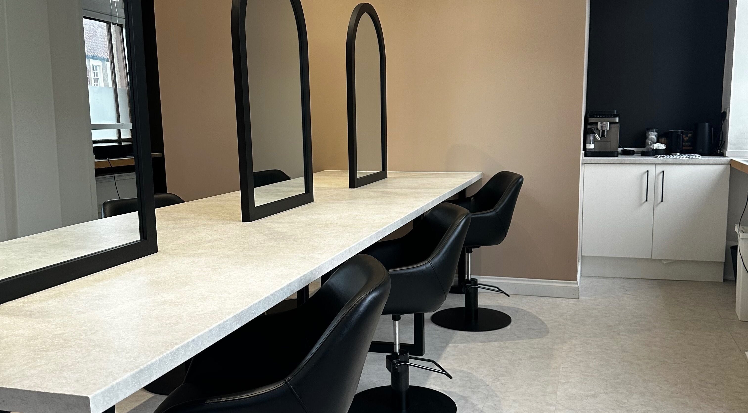 Modern seating area with sleek mirrors at Exhibit Studio, Uphall, Scotland, GB.