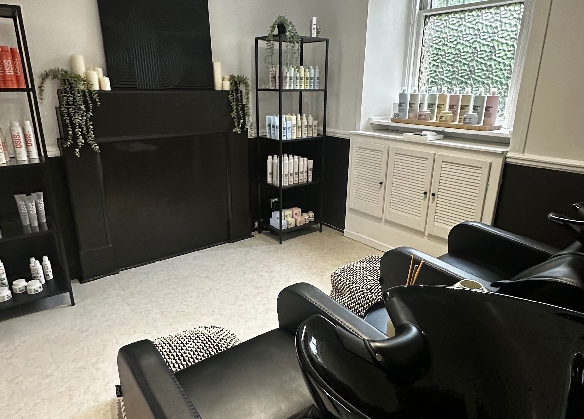Luxurious beauty station at Exhibit Studio, Uphall, Scotland, GB, with sleek chairs and top-tier products.