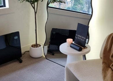 Relaxing corner at Sleeping Beauty by Phoebe, Melbourne, Victoria, AU, with candle and modern decor.
