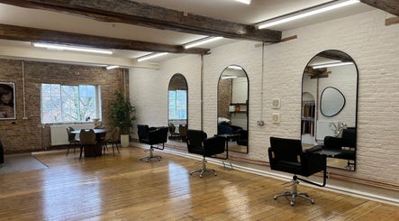 Spacious interior of Molly May Extensions Hair Salon in Gainsborough, England, GB with stylish mirrors and chairs.
