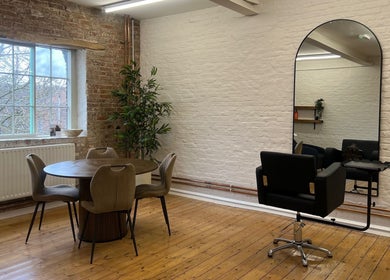 Stylish salon interior at Molly May Extensions Hair Salon, Gainsborough, England, GB, featuring a chic chair and mirror.