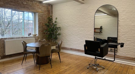 Stylish salon interior at Molly May Extensions Hair Salon, Gainsborough, England, GB, featuring a chic chair and mirror.