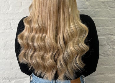Wavy blonde hair styled at Molly May Extensions Hair Salon, Gainsborough, England, GB.