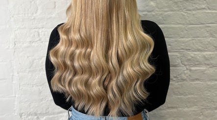 Wavy blonde hair styled at Molly May Extensions Hair Salon, Gainsborough, England, GB.
