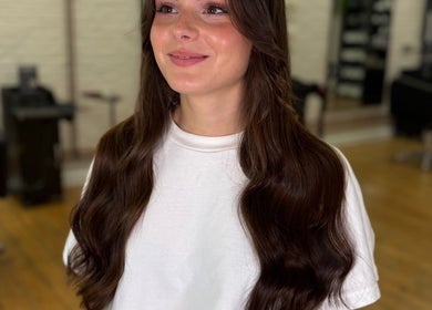 Woman with long, wavy hair at Molly May Extensions Hair Salon, Gainsborough, England, GB.